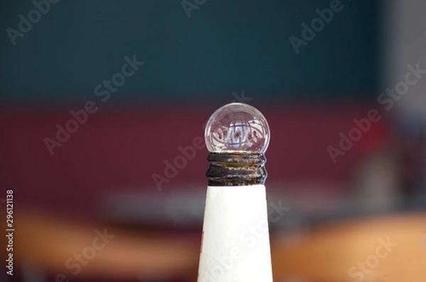 Fototapeta Bottle of beer with bubble on the top against the blured background
