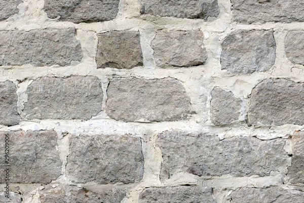 Fototapeta Seamless texture of large masonry from hand-carved blocks of a fortified wall with lime mortar.