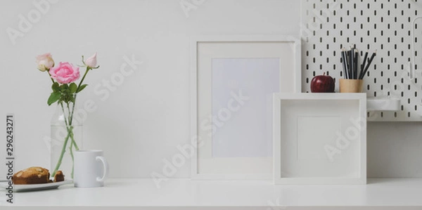 Obraz Comfortable workplace with mock up frame and copy space on white table and white wall