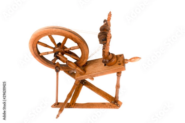 Fototapeta Closeup of old spinning wheel isolated on a white background. Very old wheel and spokes of a hand crafted spinning wheel made from natural wood. Historical working tool. Isolated, white background