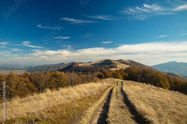Fototapeta colorful mountain landscape view photography with highland dirt trail and vivid blue sky background 