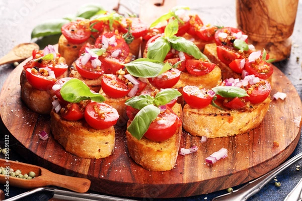 Obraz fresh tomato bruschetta. italian food appetizer with basil on table