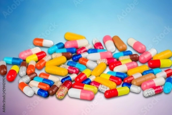 Fototapeta Colorful pills and tablets on background