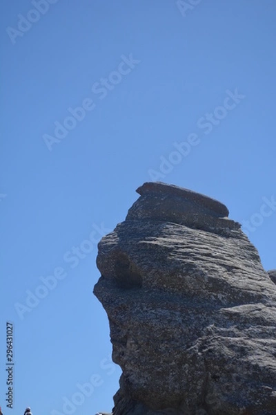Fototapeta rock on background of blue sky sphinx romania