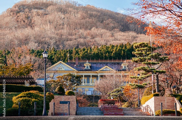Fototapeta Old Hakodate Public Hall European style building in Motomachi with Mount Hakodate in background in autumn