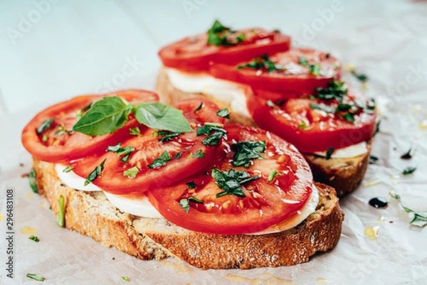 Fototapeta Caprese Toast With Mozzarella, Tomatoes And Basil