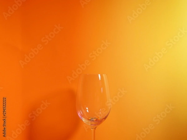 Obraz Wine glasses with orange background.