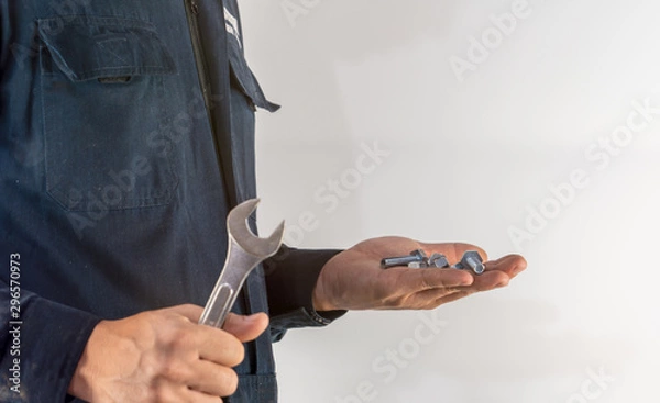 Fototapeta Mechanic hand hold  nuts and spanner tool for industrial maintenance