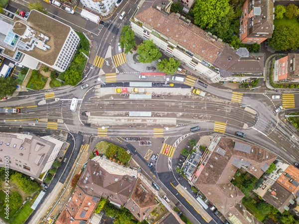 Fototapeta Aerial view of buildings with roofs. Streets with traffic in overhead view. Town in Europe from above..