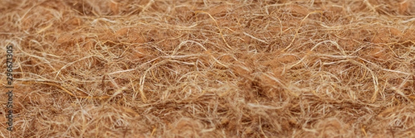 Fototapeta Rough fabric made from natural raw plant fiber. Horizontal long banner. Wallpaper and background about eco friendly material, textile industry, insulating layer for building houses.