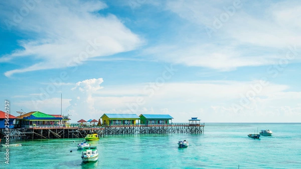 Fototapeta beautiful scenery at Derawan Island. Boats docked in the port with crystal clear water
