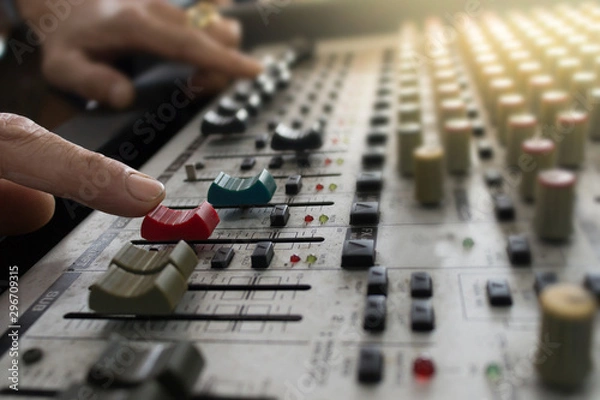 Fototapeta DJ creating songs using a mixer.