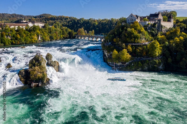 Fototapeta Rhine Falls (Rheinfall), Switzerland panoramic aerial view. Tourist boat in waterfall. Bridge and border between the cantons Schaffhausen and Zürich. Cliff-top Schloss Laufen castle, Laufen-Uhwiesen