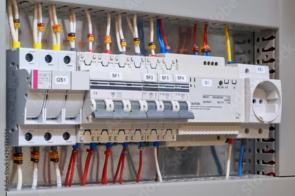 Fototapeta Fuse holder and breaker, circuit breakers, power supply and socket in the electrical Cabinet. Marked wires and cables are connected to electrical equipment. Protection of the electrical network.
