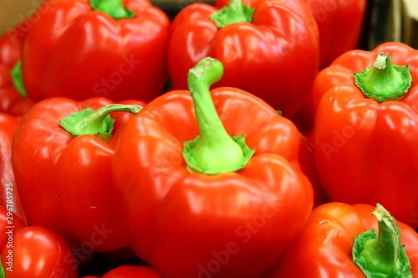 Obraz Red bell peppers on a counter in the supermarket. A large number of red peppers in a pile