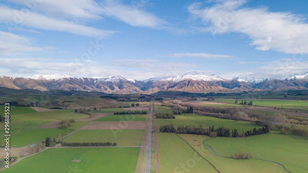 Fototapeta Amazing aerial view of green field with snowcap mountain in background.Aerial Panoramic view of Mount Cook in New Zealand.