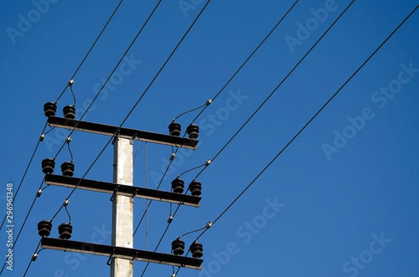 Fototapeta electric wires on a pole against a blue sky