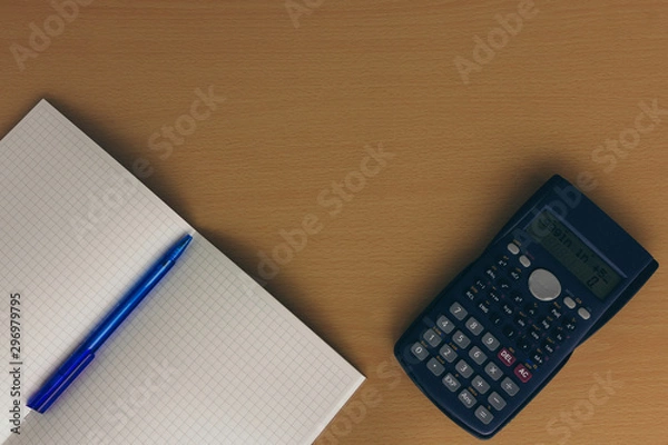 Fototapeta Note book with pencil and calculator on wood table