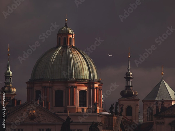 Fototapeta View of St. Francis of Assisi Church in Prague, under a dark sky.