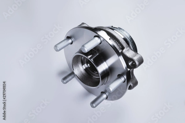 Fototapeta New Wheel hub assembly with bearing. This is part of the car suspension on a gray background with a gradient. The concept of new car parts