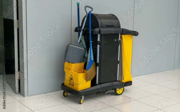 Fototapeta closeup of janitorial. yellow mop bucket and set of cleaning equipment at the airport.