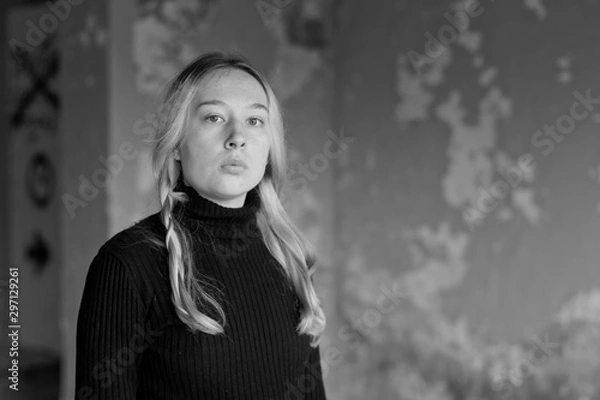 Obraz sad girl on a background of an old wall