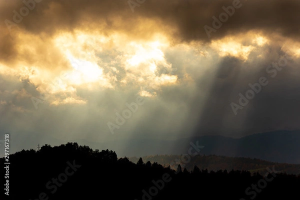 Fototapeta Dark clouds and sun rays