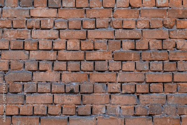 Fototapeta Texture of brick wall with peeling orange-and-gray paint