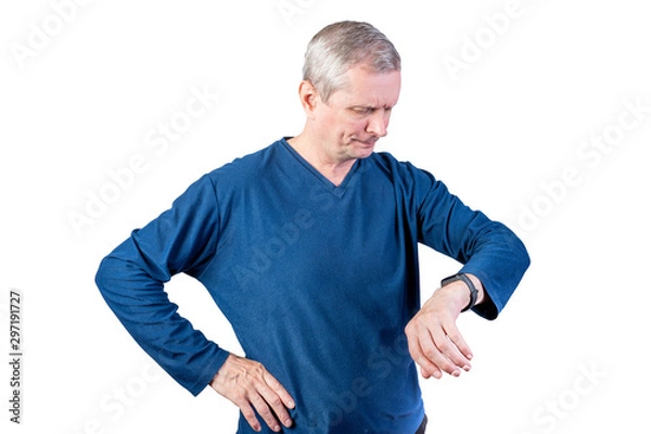 Obraz An elderly man measures the pulse of a fitness bracelet. Isolated on a white background.