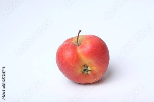 Obraz Concept of ugly food - red apple on white background