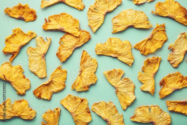 Fototapeta Dried pineapple on colored background. Pattern of a pineapple frips. Healthy eating