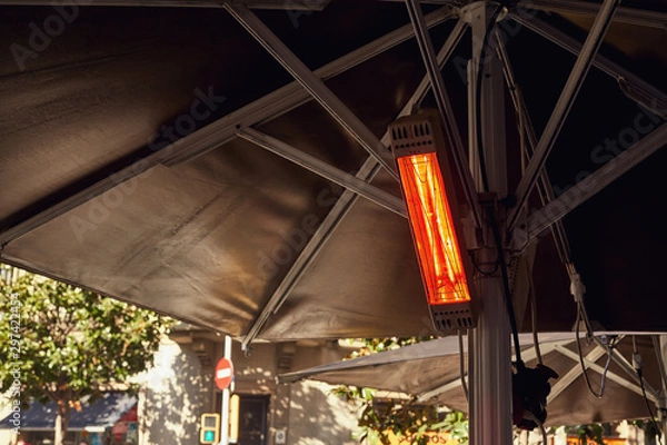 Obraz The street heater hangs switched on under the tent on the street