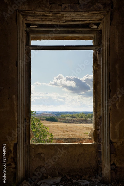 Obraz Cloudy landscape framed by a broken window