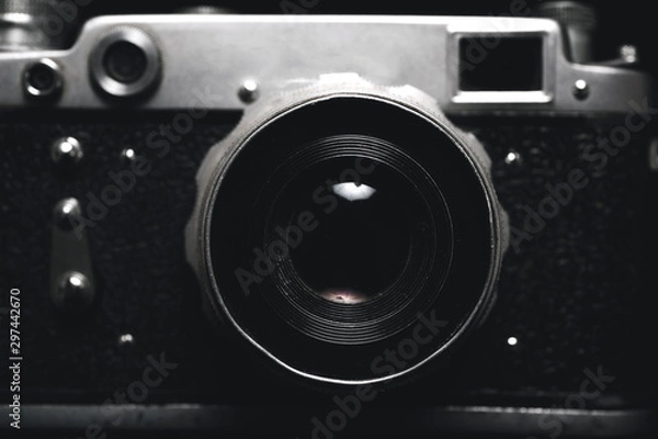 Fototapeta Vintage photo camera in darkness background, close up