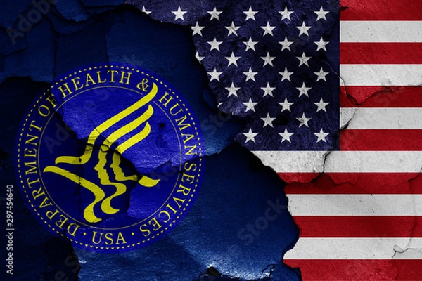 Obraz flags of Department of Health and Human Services and USA painted on cracked wall