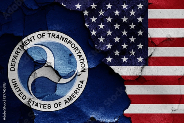 Obraz flags of Department of Transportation and USA painted on cracked wall