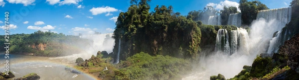 Fototapeta A panoramic of the famous Iguazu Falls with many waterfalls gushing water on the a sunny day. 