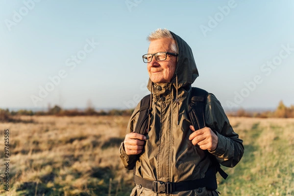 Obraz Senior man trail hiking in a mountain forest