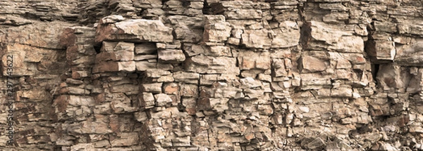 Obraz Rock cliff face background. Toned. Wild stone protruding crumbling layered blocks in quarry. Abstract texture for stone mining industry. Copy space for custom text. Front view