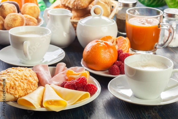 Fototapeta Fresh and continental breakfast table