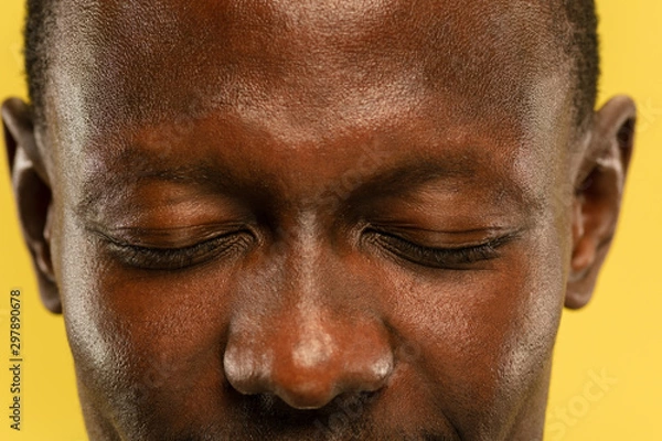 Obraz African-american young man's close up portrait on yellow studio background. Beautiful male model with well-kept skin. Concept of human emotions, facial expression, sales, ad. Eyes and cheeks.