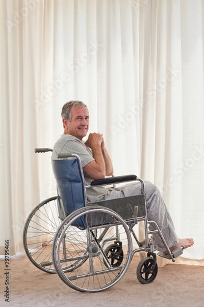 Fototapeta Smiling man in his wheelchair at home