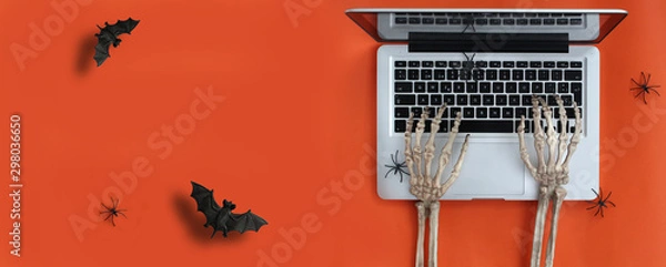 Obraz Skeleton hands typing on laptop