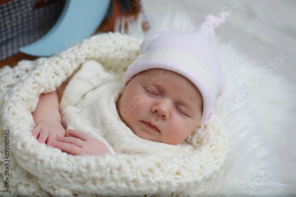 Fototapeta Baby newborn sleeping wrapped up in a blanket