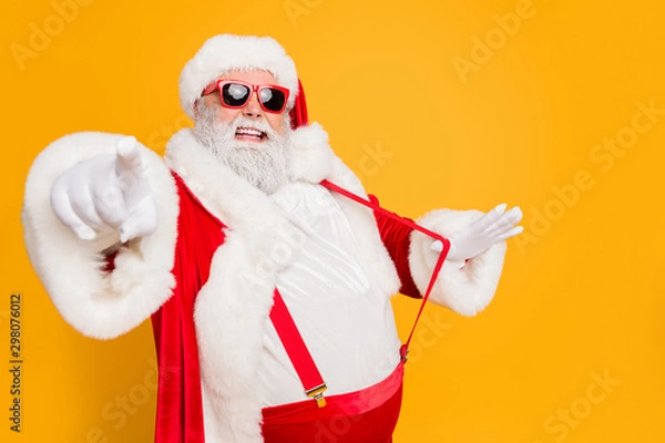Obraz Profile side photo of funky fat santa claus point index finger choose who will party with him on x-mas celebration pull stylish suspender isolated over yellow color background