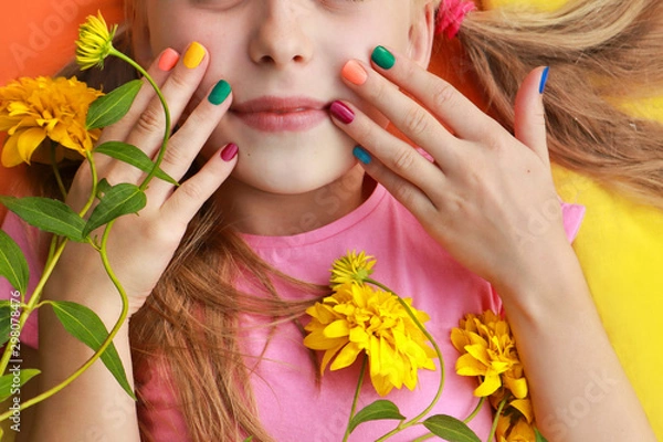 Obraz Bright and colorful children's manicure on the nails of girls with yellow flowers and good mood.