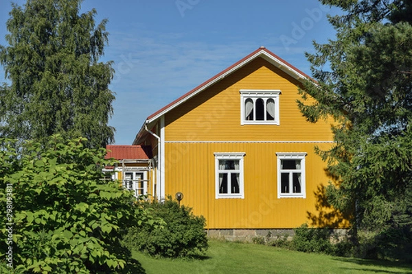 Fototapeta Yellow wooden finnish house in countyside at strawberry farm summer sunny day with green lawn and trees