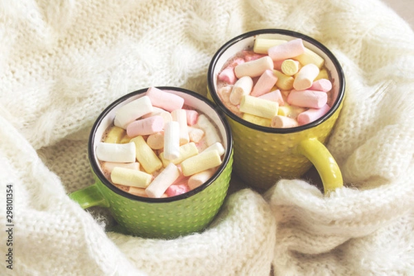 Fototapeta Winter holidays concept with cups of hot chocolate and colorful marshmallows