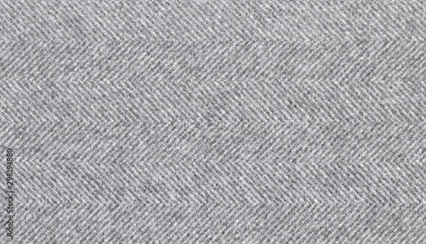 Obraz Light gray woolen fabric striped zigzag. Herringbone tweed, Wool Background Texture. Coat close-up. Expensive men's suit fabric. Virgin wool extra-fine. High resolution
