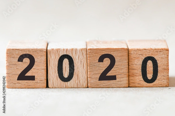 Fototapeta 2020. Wooden cube block building the word 2020.